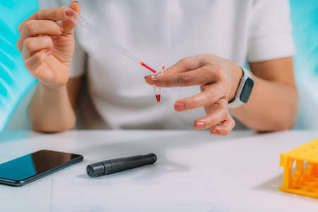 Measuring Blood Glucose Levels, Using Smart Phone App to Follow Resultsの写真素材