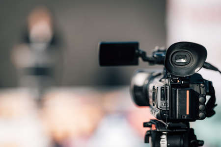 Close-up image of a camera at an outdoor press conference