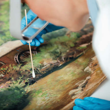 Cleaning and restoration of an old oil painting, surface cleaning process