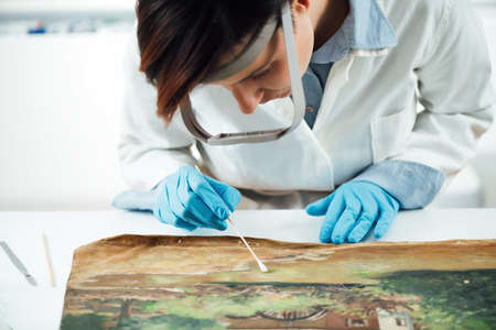 Cleaning and restoration of an old oil painting, surface cleaning processの写真素材