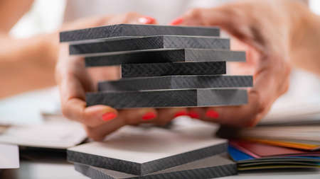 Designer holding compact board samples