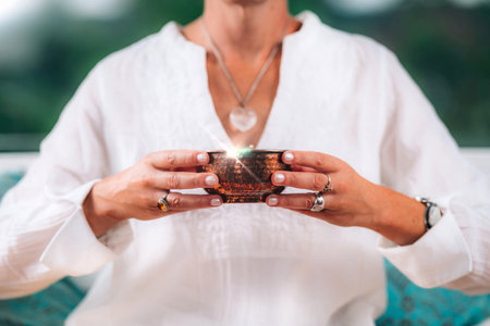 Tea drinking ritual, spiritually awaken woman paying attention to her tea in a morning tea drinking ritual.の写真素材