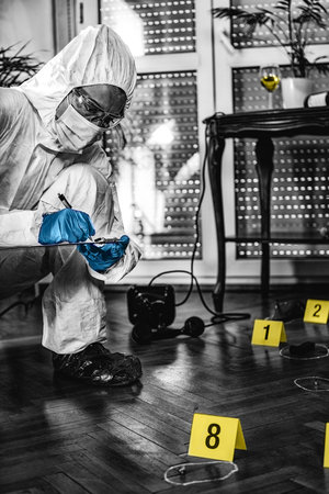 Forensic Investigator Collecting Crime Scene Evidenceの写真素材