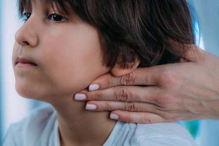 Pediatric Endocrinologist, medical doctor who specializes in the diagnosis and treatment of hormonal disorders, examining preschooler boy.の写真素材