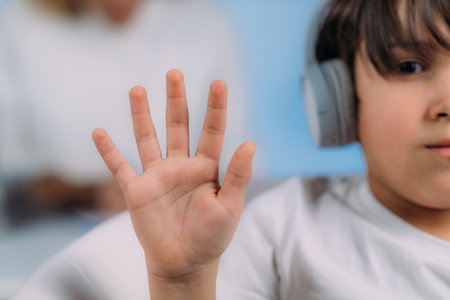 Pure tone audiometry. Test Checks Childrenâs Ability to Hear Different Pitches and Volumes of Sound. Boy with Headphones Listening Sounds of Different Pitches and Volumes, and Responds to Audiologist.の写真素材