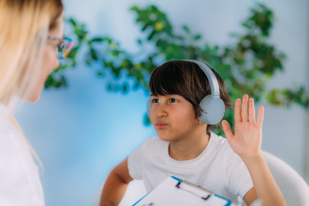 Hearing Test for Children. Early detecting hearing problems which can affect speech and language development. Audiologist Working with a Preschooler Boyの写真素材