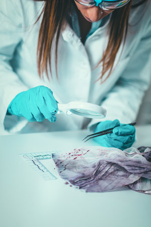 Forensic Science in Lab. Forensic Scientist examining textile with blood evidencesの写真素材