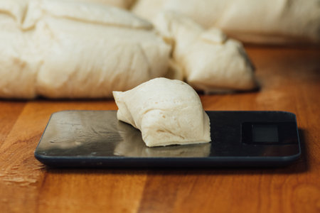 Weighing dough on a scale in large restaurant