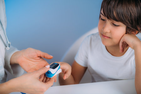 Pulmonology pediatrician measuring blood oxygen levels with pulse oximeterの写真素材