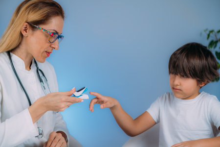 Pulmonology pediatrician measuring blood oxygen levels with pulse oximeterの写真素材