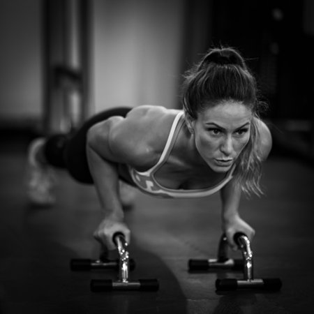 Push-up strength training, woman doing push-ups in the gym.の写真素材