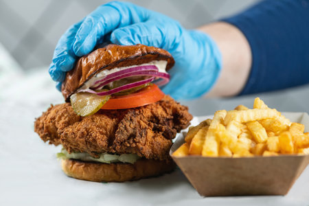 Fried chicken with various toppings, condiments and French friesの写真素材
