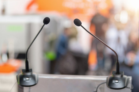 Stage with a microphones awaits the next tech visionary at a technology trade show, signaling upcoming insightful talks and industry breakthroughsの素材 [FY310206749133]