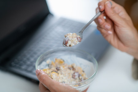 The perfect balance of work and wellness as a woman embraces healthy eating at her workplace. With a...