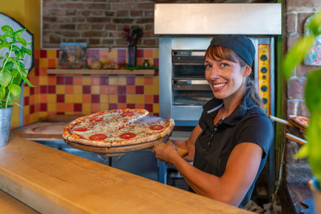 Serving delicious pizza slices in pizza shopの写真素材