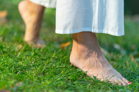 Grounded journey as a yoga woman walks barefoot, placing the spotlight on her feet. Experience the...
