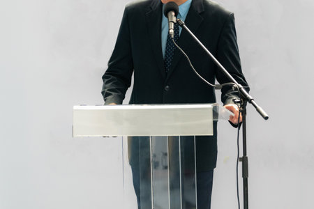 A male speaker captivates the audience with a powerful speech, creating an impactful momentの写真素材