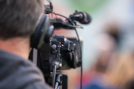 Behind the scenes, a media camera capturing the captivating moments of a dynamic event.