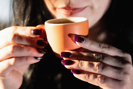 Young women exploring the rich aroma and taste of espresso coffee shop.の写真素材