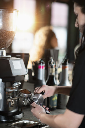 Coffee grinder creates ground coffee for the perfect espresso shot.の写真素材