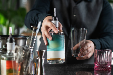 Skilled Bartender Holds A Bottle of Gin and Prepares To Make A Negroni Cocktail