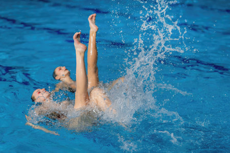 Synchronized swimming as this duet mesmerizes with fluid movements and elegant choreography in the poolの写真素材