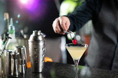 Bartender adds red Sweet Cherry, enhancing the Ginger Apple Vermouth Cocktail charm.