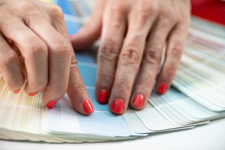 Interior designer carefully chooses compact board and colors from palette for project inspiration and coordination.の写真素材