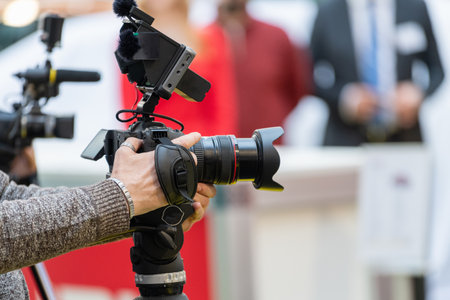 A camera records every significant moment of the opening ceremony, ensuring comprehensive documentationの写真素材