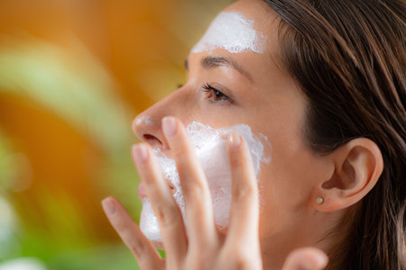 Self care moment as a woman applies a nourishing face mask in the comfort of her home
