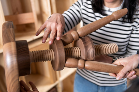 Furniture designer checking quality of a finished wooden chairの写真素材