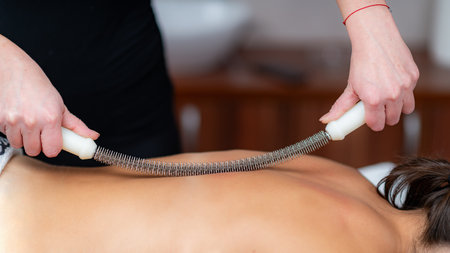 Body shaping massage as a metal rolling pin creates sculpted serenity, highlighting the elegance of this therapeutic treatmentの写真素材