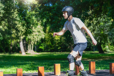 Young man rollerblading outdoors in a park, showcasing agility and energy. This vibrant scene...
