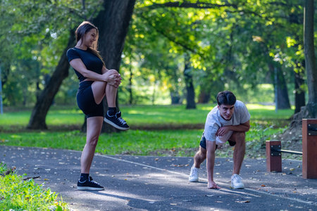 Couple exercising together in a park, promoting fitness and a healthy lifestyle. The serene outdoor...