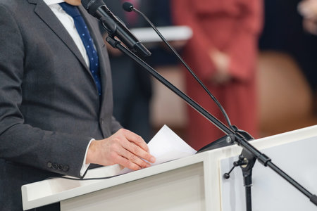 The speaker promotes accurate reporting and public trust through structured, engaging communication, conveying a focused message at a media press conference ensures clarity for journalists.の写真素材