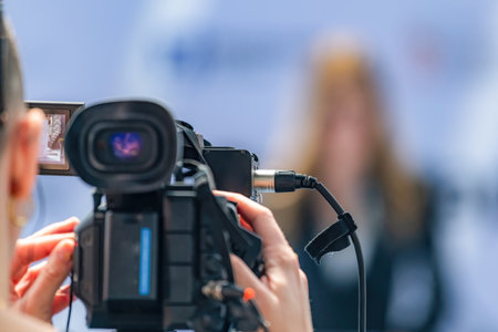 Camera at press conference records key statements, ensuring accurate media coverage. Its precise...