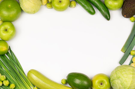Detox produce, a frame made of green color organic vegetables on white background, copy space in the middle, top viewの写真素材