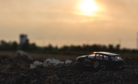 Toy car on the ground at sunset timeの写真素材