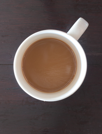 top view of coffee in white cup on wooden boardの写真素材