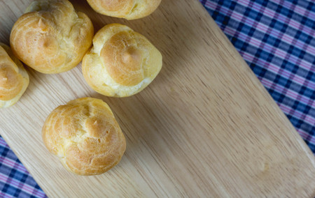 close up Choux Cream on wooden boardの写真素材
