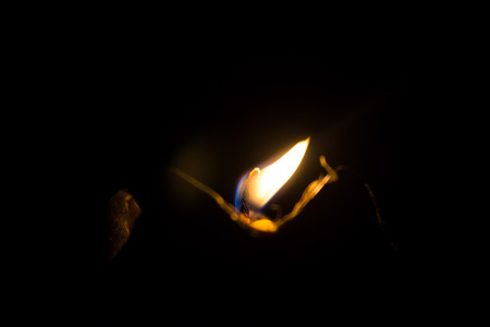 Light of candle burning in the dark. Black backgroundの写真素材