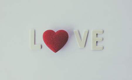 Vintage red heart and "love" on vintage white backgroundの写真素材