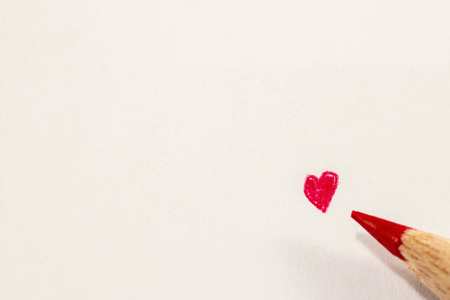 Red heart and pencil on paperの写真素材