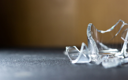 Close up broken glass on black tableの写真素材