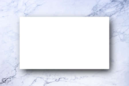 White polygonal color sheet and black shadow on marble backgroundの写真素材