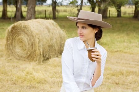 A typical Argentinean gaucha (cowgirl) drinking yerba mateの写真素材