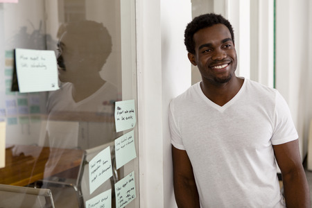 Young African American entrepreneur in his startup office smiling