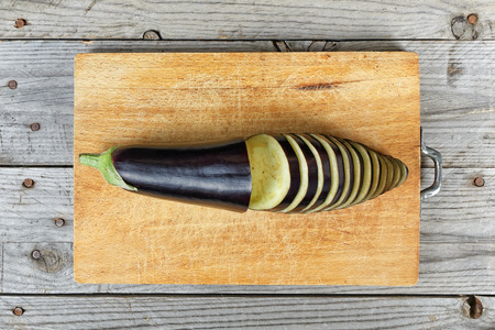 Close up of sliced ââeggplant on wooden cutting boardの写真素材