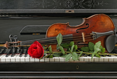 Old antique piano violin and red roseの写真素材