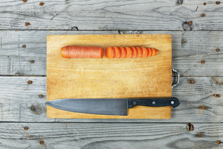 Close up of sliced carrot on wooden cutting board